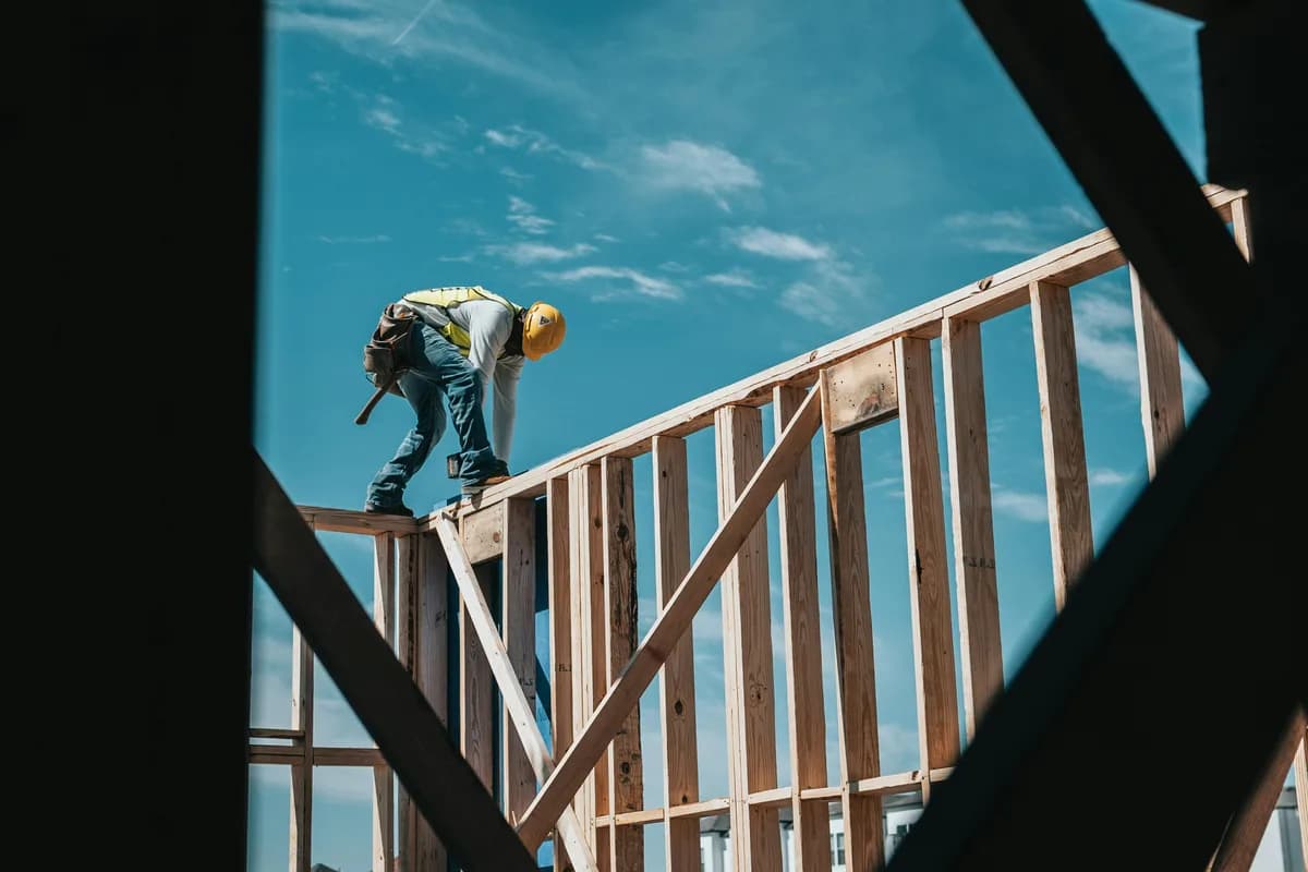 Builder in hard hat and hi-vis on an active UK construction site