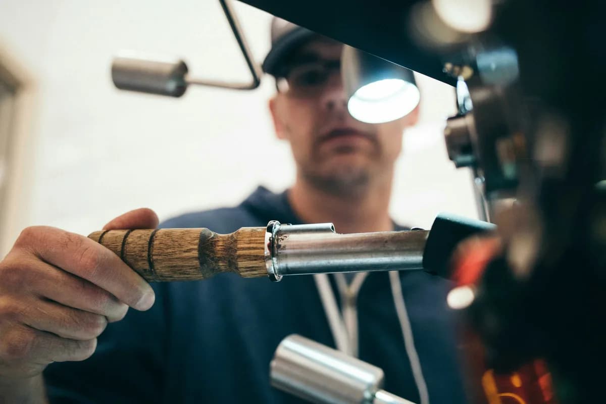 Plumber installing pipework under a kitchen sink in a UK home